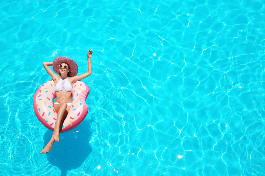 girl floating in pool on inflatable raft